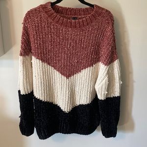 Pink, white, and black knitted sweater